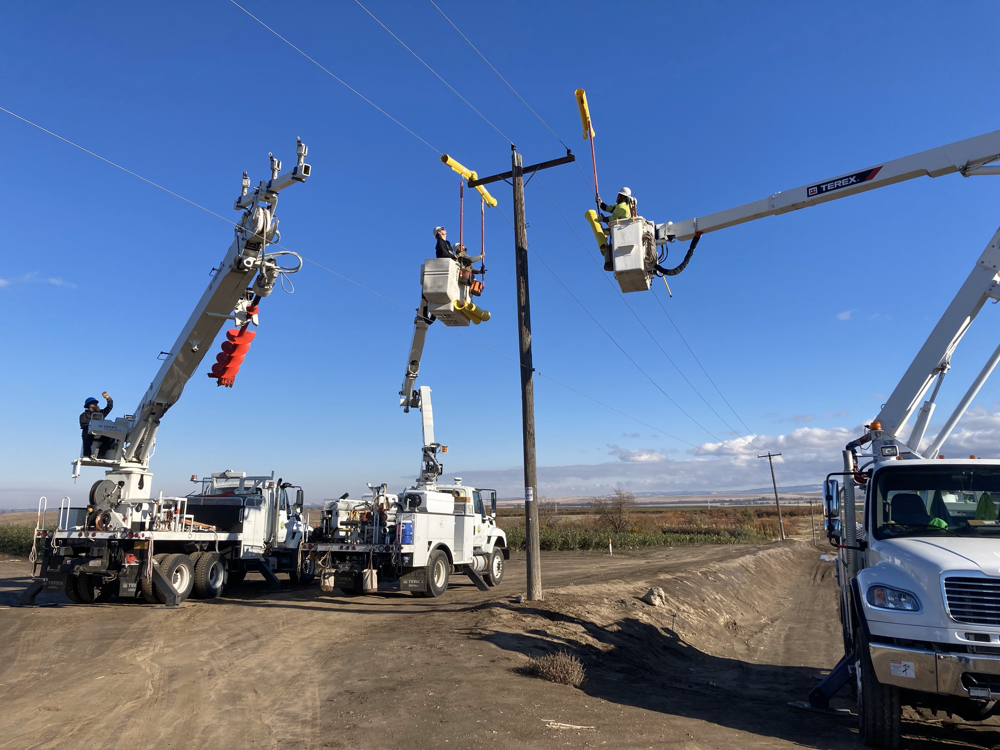 Line crew placing coverup over energized lines